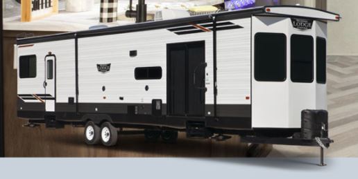 Two 2019 Prime Time Avenger 21TH Trailers parked under a night sky